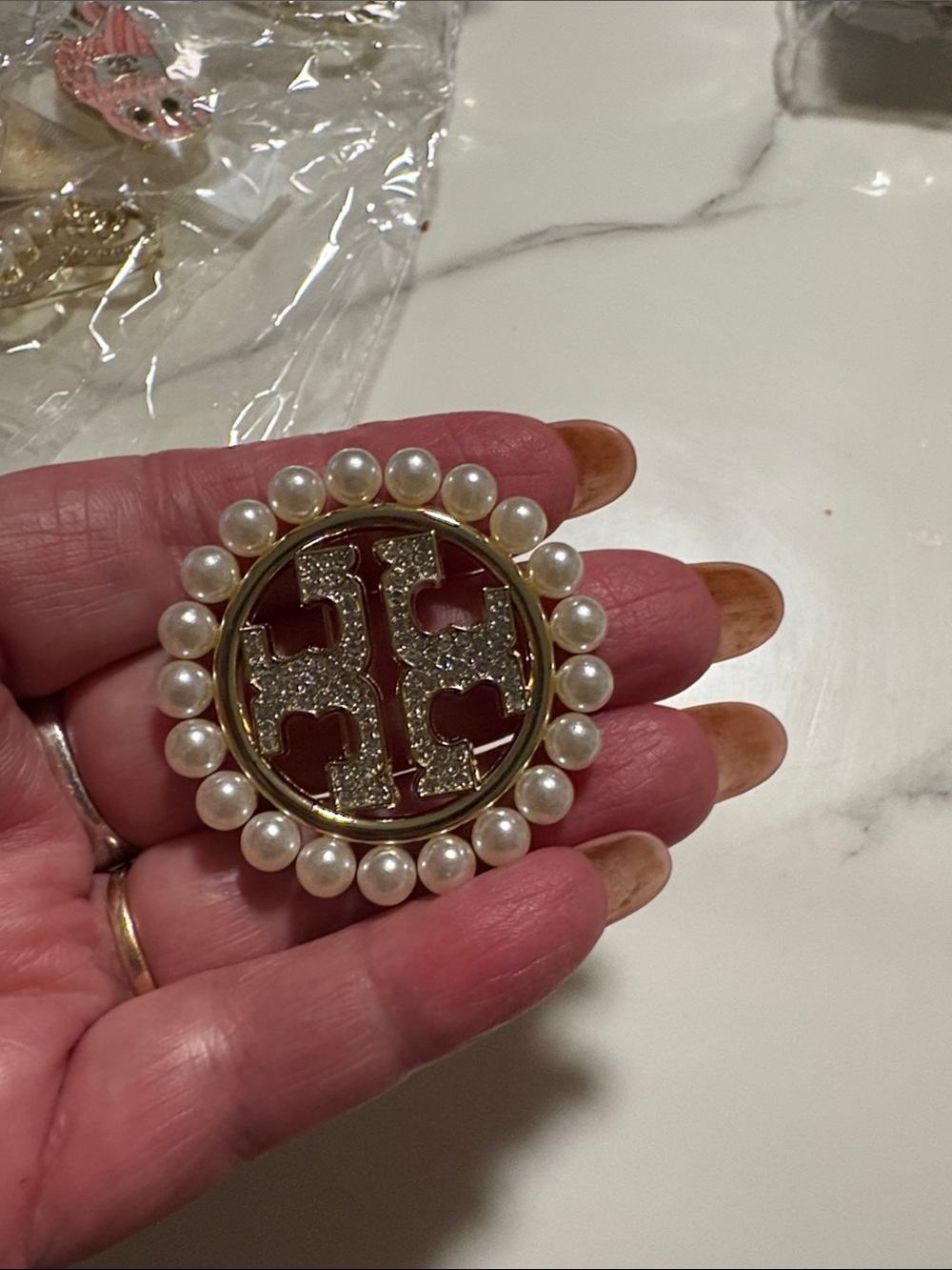 Pearl-Trim Gold & Crystal Logo Brooch - Pink Accent